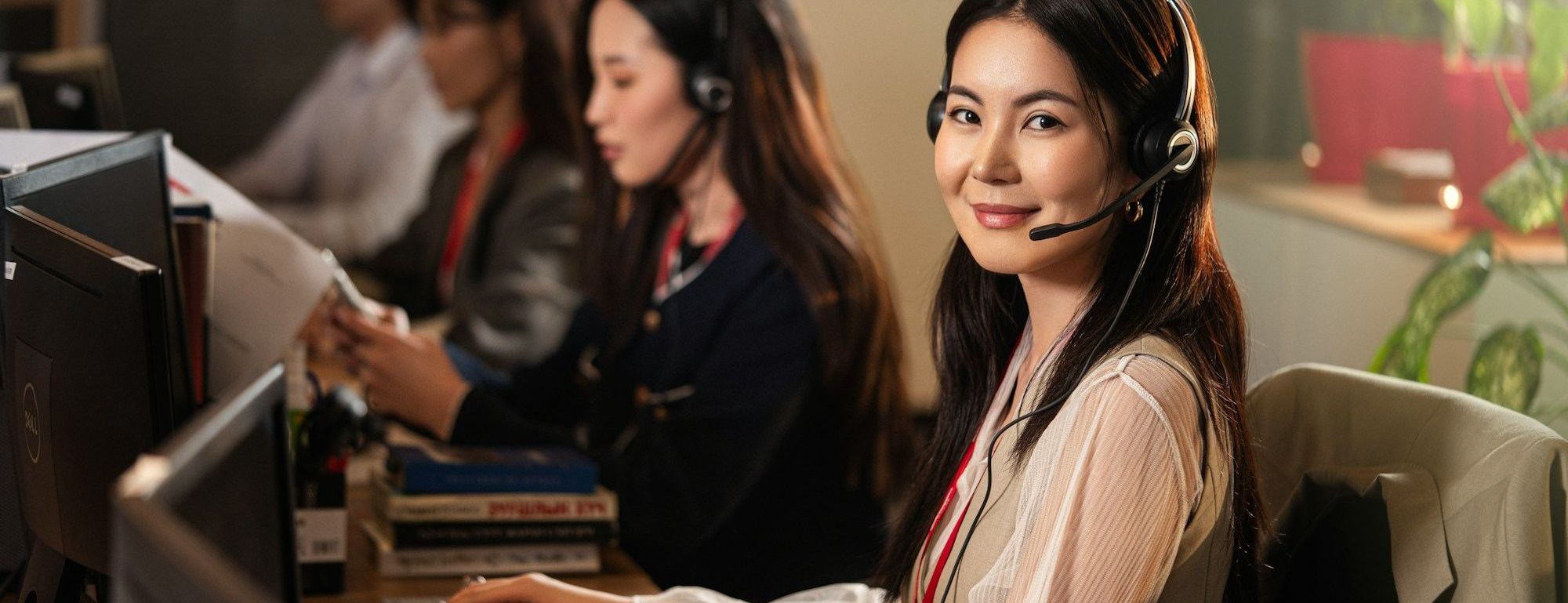 Contact centre agents wearing headsets at their desks